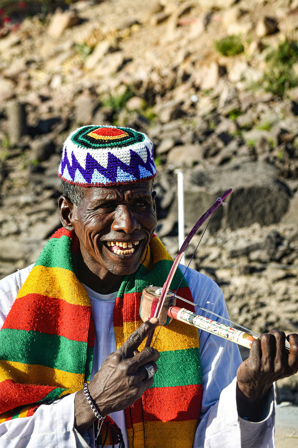 A nubian man playing a traditional musical instrument